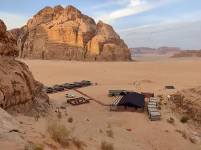 a camping area in the desert with a mountain at Rehana rum luxury camp in Wadi Rum