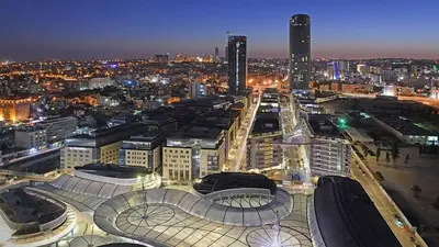 a view of a city at night with buildings at Luxury Studio DAMAC TOWER - 1 BEDROOM -JORDAN in Amman