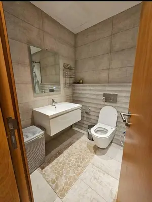 a bathroom with a toilet and a sink at Luxury Studio DAMAC TOWER - 1 BEDROOM -JORDAN in Amman