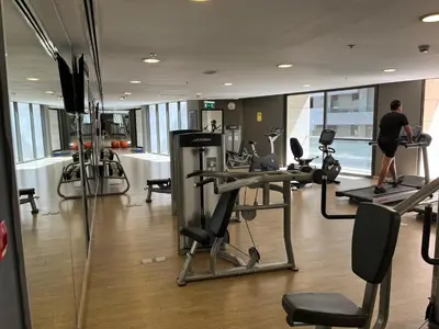 a gym with a man on a treadmill in a building at Luxury Studio DAMAC TOWER - 1 BEDROOM -JORDAN in Amman