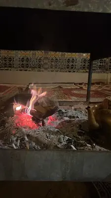 a grill with a fire in the middle of it at Montana Camp wadi rum in Wadi Rum