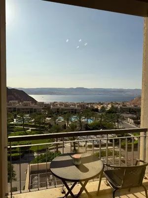 a balcony with a table and a view of the ocean at Rental unit in RAHA village compound, special view in Aqaba