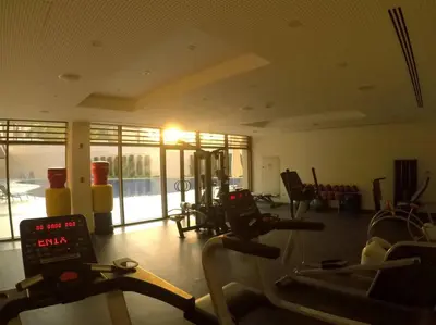 a gym with cardio equipment in a large room at Rental unit in RAHA village compound, special view in Aqaba