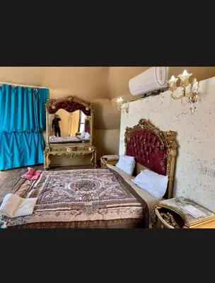 a bedroom with a large bed with a mirror at Sun rise wadi rum camp in Wadi Rum