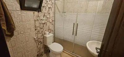 a bathroom with a toilet and a sink at شقة مفروشة فرش فاخر ٣ غرف نوم في طبربور عمان in Amman