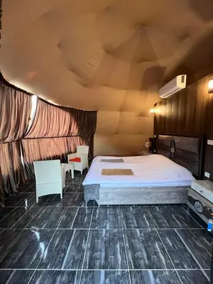 a bedroom with a bed and a wooden ceiling at Orbit camp in Wadi Rum