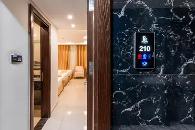 a clock on the wall of a hallway with a room at Petra Elite Hotel in Wadi Musa
