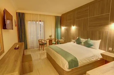 a hotel room with a bed and a table at Turquoise Hotel in Aqaba