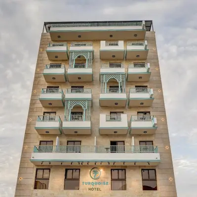 a tall building with balconies on the side of it at Turquoise Hotel in Aqaba