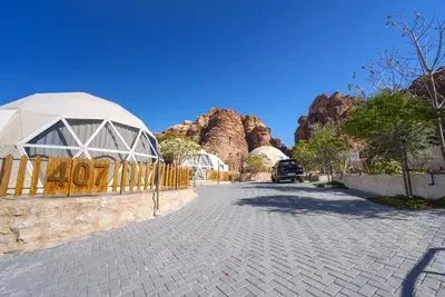 a cobblestone street in front of a mountain at The Rock Camp Petra in Wadi Musa