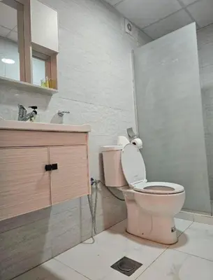 a bathroom with a pink toilet and a sink at Rum Aranda camp &Bubbles Hotel in Wadi Rum