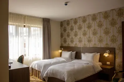 a hotel room with two beds and a window at Khan Khediwe Hotel in Amman
