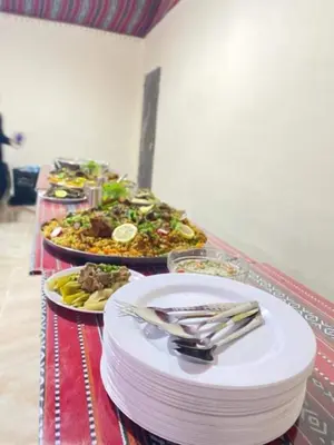 a buffet with several plates of food on a table at wadi rum land mars in Wadi Rum