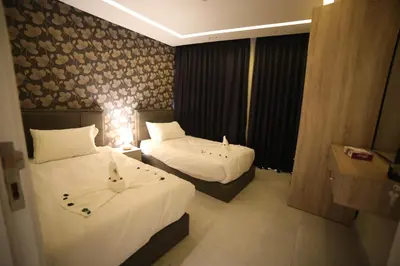 a hotel room with two beds with cats on them at فندق صحارى الخليج Sahara Gulf Hotel Apartments in Amman