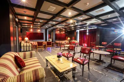 a restaurant with couches and tables and chairs at Century Park Hotel in Amman