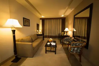a living room with a couch and a table at Century Park Hotel in Amman