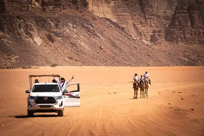 a group of people riding horses in the desert at Wadi Rum Mirror Camp in Wadi Rum