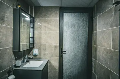 a bathroom with a sink and a shower at Wadi Rum Mirror Camp in Wadi Rum