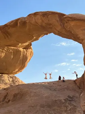 a group of birds jumping off of a rock formation at rum rema camp in Wadi Rum