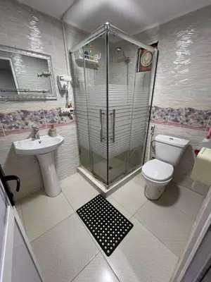 a bathroom with a shower and a toilet and a sink at Petra Royal Ranch in Wadi Musa