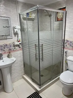 a bathroom with a shower and a toilet and a sink at Petra Royal Ranch in Wadi Musa