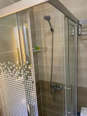 a shower with a glass door in a bathroom at Asad Apt. in Wadi Musa