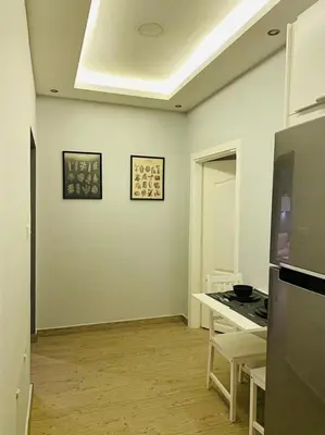 a kitchen with a stove and a counter top at Elite Corner Apartment in Ţāb Kirā‘