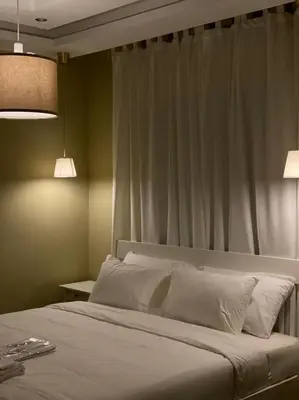 a bedroom with a large bed with white pillows at Elite Corner Apartment in Ţāb Kirā‘