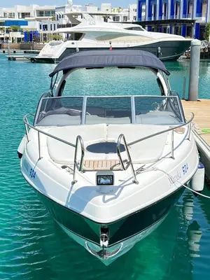a white boat is docked in the water at Roza Beach Aqaba in Aqaba