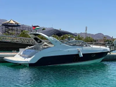 a boat is docked at a dock in the water at Roza Beach Aqaba in Aqaba