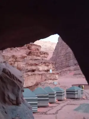 a view of the desert from an opening in the rock at Wadi Rum White Mountain Camp in Wadi Rum