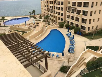an overhead view of a swimming pool in a resort at Spacious apartments with Sea view at Samarah Resort in Sowayma
