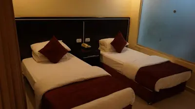 a hotel room with two beds and a window at petra agora hotel in Wadi Musa