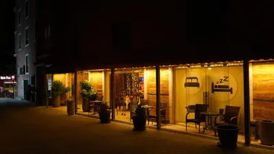 a store front at night with chairs and tables at petra agora hotel in Wadi Musa