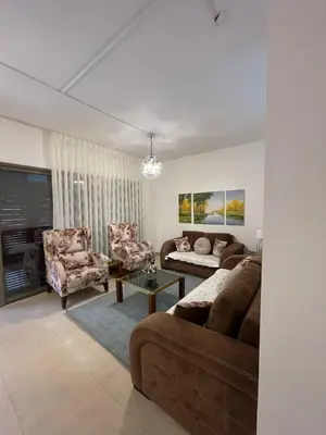 a living room with a couch and chairs and a table at Romantic chalet between swimming pools and close to the seashore for families only in Aqaba