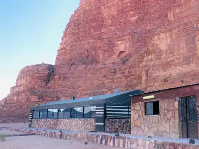 a building in front of a rock mountain at Bedouins nights in Wadi Rum
