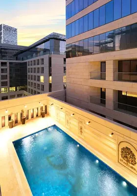 a large swimming pool on the side of a building at Luxury Apartment in DAMAC Towers in Amman