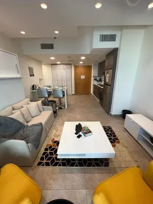 a living room with a couch and a table at Luxury Apartment in DAMAC Towers in Amman