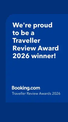 a blue sign that says were proud to be a traveller reviewagency winner at Maria Home in Madaba