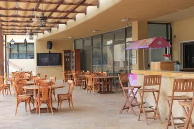 a restaurant with tables and chairs and a bar at Samarah Dead Sea Resort Studio-CP6 Traveler Award 2026 Winner Thursday, Friday and Saturday Groups consisting solely of male guests are not permitted in Sowayma