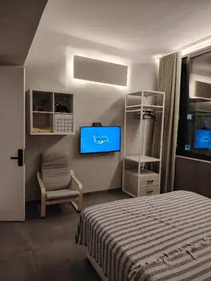 a bedroom with a bed and a tv on the wall at Rooftop one room غرفه نوم فقط in Amman