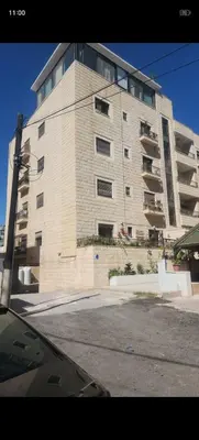 a large apartment building with a large building at Rooftop one room غرفه نوم فقط in Amman