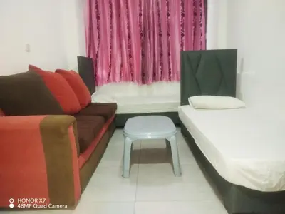 a living room with a couch and a stool at Farah Plaza Hostel &Hotel Apartments in Aqaba