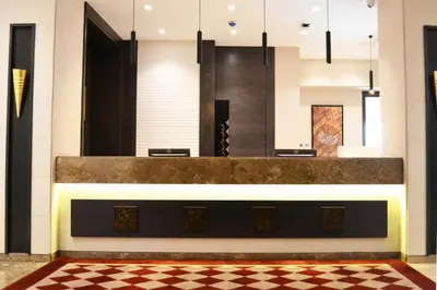 a lobby with a reception desk and a checkered floor at Ambassador, a Boutique Hotel in Amman