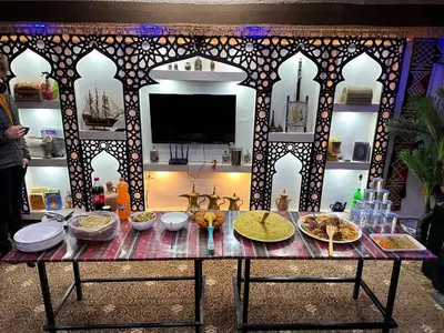 a table with plates of food on top of it at Wadi Rum Oryx Hostel & Tours in Wadi Rum