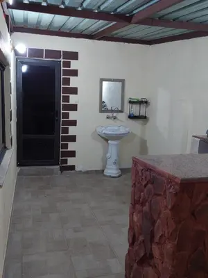 a bathroom with a sink in a room at Wadi Rum Oryx Hostel & Tours in Wadi Rum