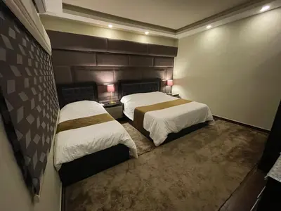 a hotel room with two beds and two lamps at Oqdeh studio in Jerash