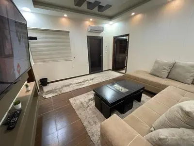 a living room with a couch and a coffee table at Oqdeh studio in Jerash