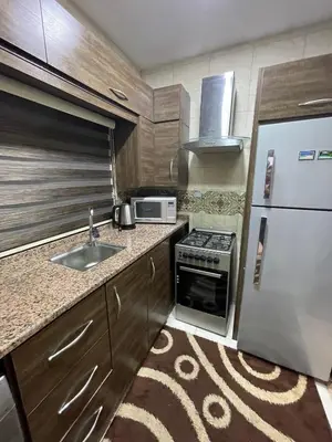 a small kitchen with a sink and a refrigerator at Oqdeh studio in Jerash
