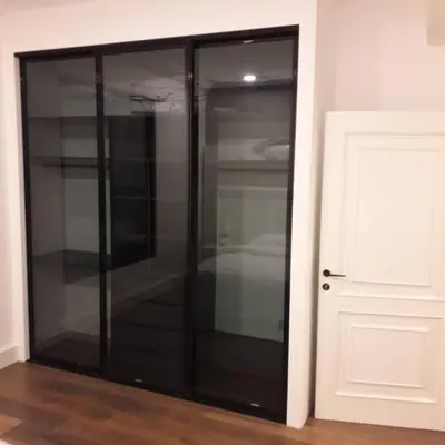 a black cabinet in a room next to a door at Exquisite Modern 2-bedroom Rental Unit in Amman